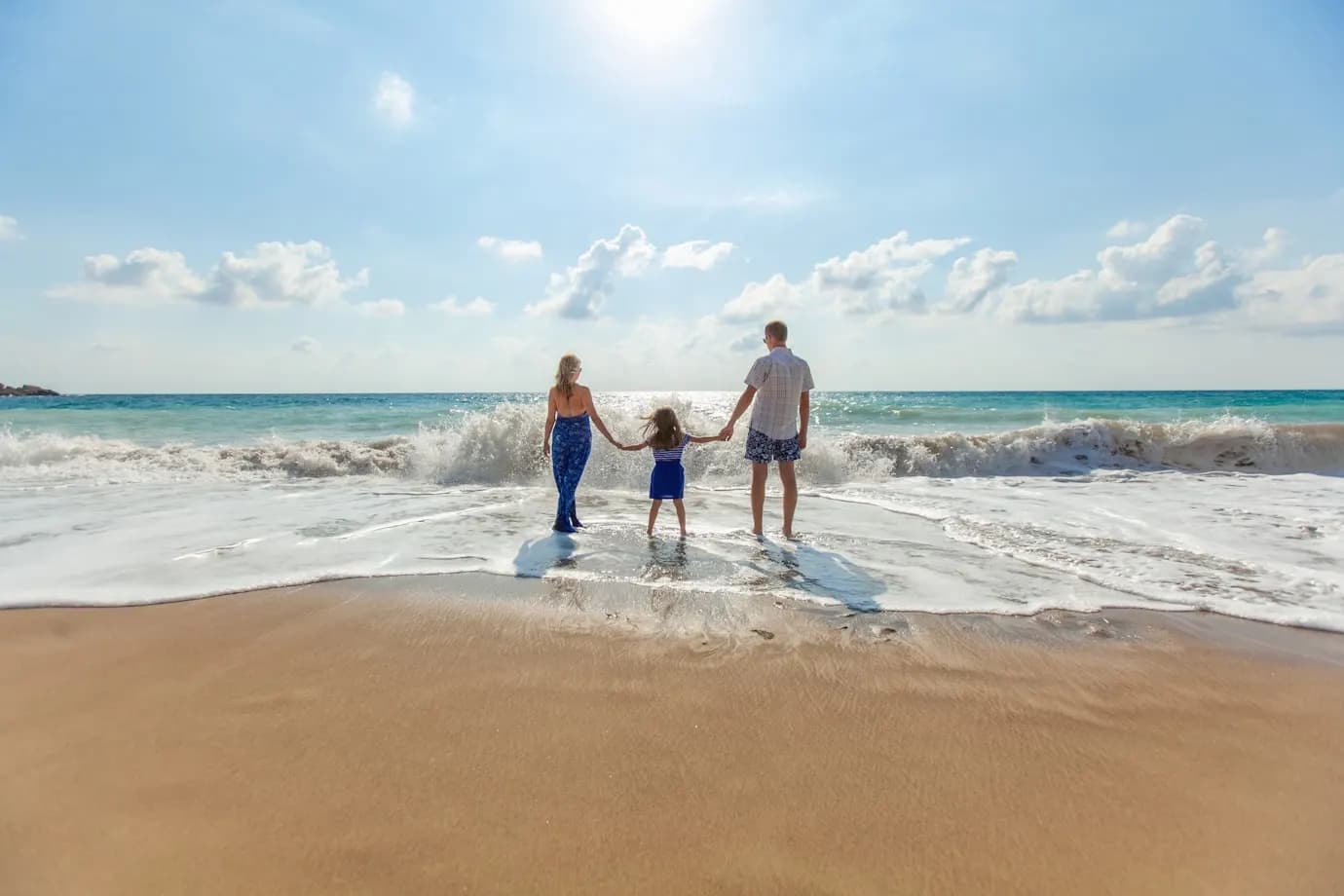 Family walking on a sunny beach